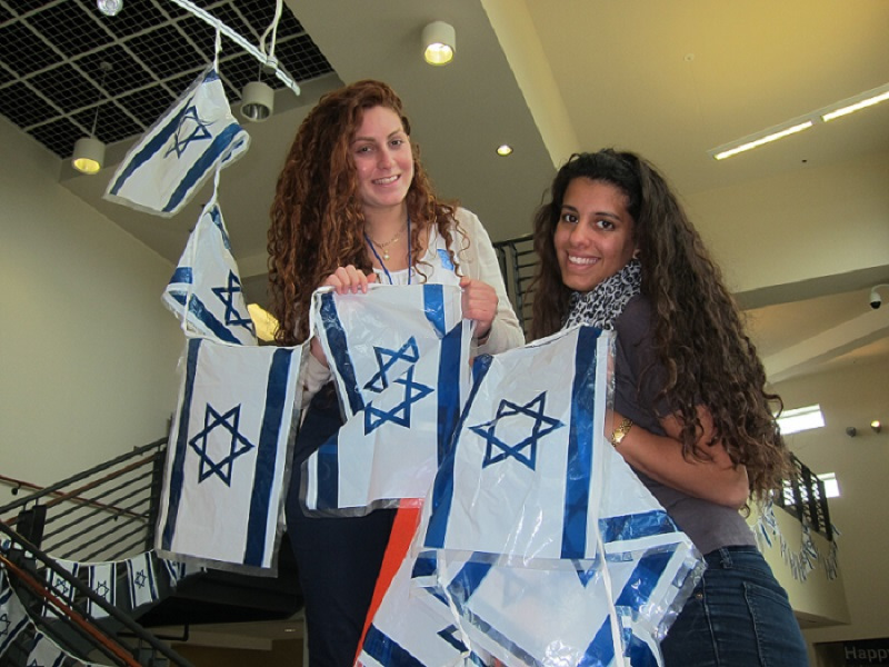 Past Chaverim decorate the Mayerson JCC with Israeli flags.